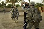 File - U.S. Army Staff Sgt. David Tredway, of Bravo Troop, 5th Squadron, 73rd Calvary Regiment, 3rd Brigade Combat Team, 82nd Airborne Division, restrains and searches a detainee during a mission in Al Haymer, Iraq, July 12, 2007.