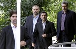 Escorted by his bodyguards, Iranian President Mahmoud Ahmadinejad, second right, arrives for an official welcoming ceremony for the president of the Presidium of North Korea's Supreme People's Assembly Kim Yong Nam, in Tehran