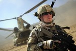 U.S. Army Staff Sgt. James Bates, a security force squad leader with the Farah Provincial Reconstruction Team (PRT), provides security at a landing zone as his team prepares to disembark a CH-47 Chinook helicopter Sept. 26, 2012, in Pur Chaman district, Farah province, Afghanistan. The Farah PRT was composed of Soldiers, Sailors and Airmen whose mission was to provide security, support local governments and monitor reconstruction efforts throughout the province.