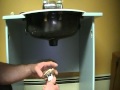 Old plumber shows how to install a bathroom sink (basin) drain.POplug... plug and chain