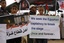 Palestinians hold slogans which read in Arabic "Oh free people, remove the blockade for us" (L) during a protest against the Egyptian decision to close the smuggling tunnels along the Gaza-Egypt border in Rafah, in the southern Gaza Strip on October 1, 2012. Since last month, Egyptian military have destroyed about 30 tunnels and blocked more which were used for smuggling to and from the Gaza Strip. The tunnels are a vital lifeline for supplies of food, clothes, building materials and fuel into the impoverished Palestinian territory subjected to an Israeli blockade since 2006.Photo by Ahmed Deeb / WN