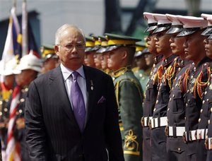 Malaysian Prime Minister Najib Razak reviews the troops during welcoming ceremony at Malacanang Palace grounds in Manila, Philippines Monday Oct. 15, 2012.