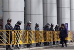 File - Thai riot police officers stand in line at the criminal court building in Bangkok, Thailand, Thursday, Aug. 9, 2012. Hundreds of "Red Shirt" supporters gathered outside a Bangkok court to learn whether their leaders will return to prison.