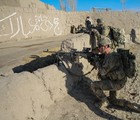 File - Spc. Wickham, an infantryman and 240B gunner, and another soldier, assigned to Company D, 1st Battalion, 187th Infantry Regiment, 3rd Brigade Combat Team, 101st Airborne Division (Air Assault), pull rear security while on a short halt during an Afghan National Security Forces-led mission in rural areas of Zormat district, Afghanistan, Dec. 10, 2012.