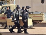 Algerian firemen carry a coffin containing a person killed during the gas facility hostage situation at the morgue in Ain Amenas, Algeria, Monday, Jan. 21, 2013.