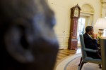 A bronze bust of Dr. Martin Luther King, Jr. is visible in the foreground as President Barack Obama meets with senior advisors, in the Oval Office, Feb. 4, 2010.