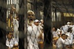 File - Egyptian defendants who face charges relating to the deaths after a soccer match in the Mediterranean city of Port Said Feb. 1, 2012, chant slogans inside a cage during their trial at a court house in Cairo Egypt, Tuesday, April 17, 2012.