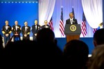 President Barack Obama delivers his remarks with the all the Senior Enlisted Members representing their perspective service at the Commanders in Chief Ball on January 21, 2013 at the Washington Convention Center in Washington, D.C.