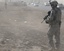 Staff Sgt. Kyle Henry, right, a section chief with Battery A, 1st Battalion, 7th Field Artillery Regiment, 2nd Advise and Assist Brigade, 1st Infantry Division, conducts a dismounted force protection patrol near an Iraqi 1st Federal Police check point, 26 July, 2011, Iraq.