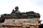 File - U.S. Army Pfc. Donivan Dean, 2nd Platoon, Alpha Company, 1st Brigade, 37th Armor Battalion, 1st Brigade Combat Team, 1st Armored Division, finds a spot to maintain a security overwatch as members of the Iraqi Army's 3rd Company, 1st Battalion, 46th Brigade, 12th Iraqi Army Division, conduct a Flash Traffic Control Point by the Schmit Bridge in Zaab, Iraq, Feb. 27, 2010.