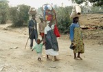 File - Rwandan refugees returning from Goma, Zaire, 26 July 1994, following the Rwandan genocide during which over 500,000 people were killed, according to a Human Rights Watch estimate.