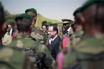 In this photo taken Saturday, Feb. 2, 2013, French President Francois Hollande addresses the troops at the airport following his two-hour-long visit to Timbuktu, Mali.