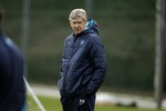 Arsenal's French manager Arsene Wenger waits for all the players to arrive at the start of a training session at the club's facilities in London Colney, England, Tuesday, Feb. 14, 2012. Arsenal are due to play AC Milan in the first leg of their Champions League last 16 soccer match in Milan on Wednesday.