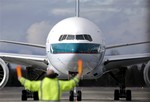 A Boeing 777-367 (ER) Cathay Pacific jet is guided to a parking spot by a marshaller at Paine Field Tuesday, Feb. 5, 2013, in Everett, Wash.