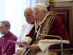 In this photo provided by the Vatican newspaper L'Osservatore Romano, Pope Benedict XVI reads a document in Latin where he announces his resignation, during a meeting of Vatican cardinals, at the Vatican, Monday, Feb. 11, 2013.