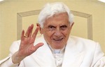 Pope Benedict XVI waves to faithful during his weekly audience in St. Peter's square at the Vatican, Wednesday, April 11, 2012.