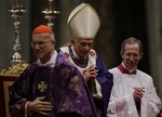 Vatican Secretary of State Cardinal Tarcisio Bertone walks past Pope Benedict XVI at the end of the Ash Wednesday mass in St. Peter's Basilica at the Vatican, Wednesday, Feb. 13, 2013.