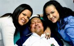 In this photo released Friday, Feb. 15, 2013 by Miraflores Presidential Press Office, Venezuela's President Hugo Chavez, center, poses for a photo with his daughters, Maria Gabriela, left, and Rosa Virginia at an unknown location in Havana, Cuba, Thursday, Feb. 14, 2013.