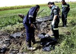 Egyptian rescue workers collect remains at the scene of a balloon crash outside al-Dhabaa village, just west of the city of Luxor, 510 kilometers (320 miles) south of Cairo, Egypt, Tuesday, Feb. 26, 2013.