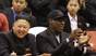 North Korean leader Kim Jong-unn, left, and former basketball star Dennis Rodman watch North Korean and U.S. players in an exhibition basketball game at an arena in Pyongyang