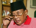 Filipino Sultan Jamalul Kiram III arranges his glasses inside his residence in Taguig, south of Manila, Philippines on Thursday, March 7, 2013.