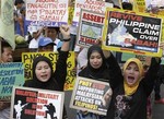 Filipino Muslims are joined by other protesters as they shout slogans during a rally near the Presidential Palace in Manila, Philippines Wednesday, March 6, 2013, to protest the military assault by Malaysian forces on nearly 200 Filipinos occupying a Borneo coastal village.