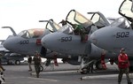 A deck crew member checks an EA-6B Prowlers on the USS George Washington during joint military drills in South Korea's East Sea on Sunday, July 25, 2010.