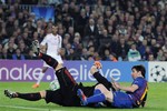 FC Barcelona's Lionel Messi from Argentina, bottom right, falls on the pitch with AC Milan's goalkeeper Christian Abbiati during their Champions League second leg, quarterfinal soccer match, at Camp Nou stadium in Barcelona, Spain Tuesday April 3, 2012. FC Barcelona won the match 3-1.