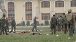 The body of an alleged militant lies on a school compound following an attack against Indian paramilitary personnel in Srinagar on March 13, 2013. Five paramilitary police were killed March 13 in an ambush on security forces in the main city of Indian Kashmir carried out by two militants who were then shot dead, a senior officer said.