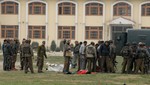 The body of an alleged militant lies on a school compound following an attack against Indian paramilitary personnel in Srinagar on March 13, 2013. Five paramilitary police were killed March 13 in an ambush on security forces in the main city of Indian Kashmir carried out by two militants who were then shot dead, a senior officer said.