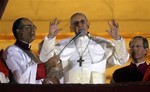 Pope Francis waves to the crowd from the central balcony of St. Peter's Basilica at the Vatican, Wednesday, March 13, 2013.