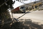 Palestinian workers inspect one of several trucks carrying supplies after it arrived in Rafah town through the Kerem Shalom crossing between Israel and the southern Gaza Strip on March 5, 2013. Israel reopened the Kerem Shalom commercial crossing into southern Gaza, six days after closing it after a rocket fired from the Palestinian enclave hit the Jewish state.Photo by Ahmed Deeb / WN