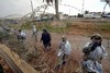 File - Egyptian soldiers use barbed wire to close a part of a destroyed section of the border wall between the Gaza Strip and Egypt January 29, 2008.