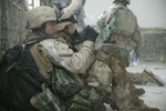 File - U.S. Marines take a break while searching the city of Al Fallujah, Iraq, for insurgents and weapons during Operation al Fajr (New Dawn) on Nov. 9, 2004.