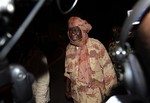 File - Central African Republic rebel leader Michel Djotodia is met by journalists as he arrives ahead of planned peace talks with the Central African Republic's government, at the airport in Libreville, Gabon, Monday, Jan. 7, 2013.