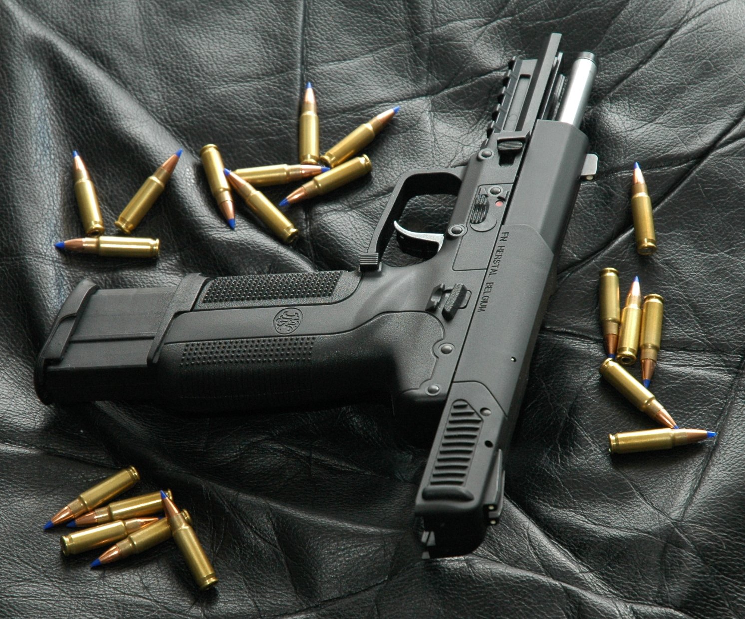 Photo of an all-black Five-seven USG with its slide locked back