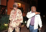 File - Central African Republic rebel leader Michel Djotodia, left, walks with Guy-Pierre Garcia, deputy secretary-general of the Economic Community of Central African States, as the rebel delegation arrives ahead of planned peace talks with the Central African Republic's government, at the airport in Libreville, Gabon, Monday, Jan. 7, 2013.