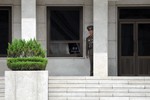 File - A North Korean soldier stands watch on the North Korean side of the Demilitarized Zone as U.S. Sailors assigned to the Ronald Reagan Carrier Strike Group tour the DMZ in Panmunjom, South Korea, July 17, 2008.