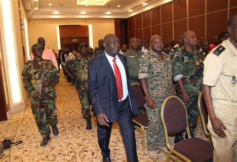 Michel Djotodia, center, the rebel leader who declared himself president over the weekend after his soldiers seized the capital, arrives for a meeting with members of the government armed forces, in Bangui, Central African Republic, Thursday, March 28, 2013.