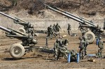 South Korean army soldiers prepare 155 mm howitzers during an exercise against possible attacks by North Korea near the border village of Panmunjom in Paju, South Korea, Thursday, March 14, 2013.