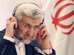 Iran's Supreme National Security Council Secretary and chief nuclear negotiator Saeed Jalili listens to a question during a final news conference in Almaty