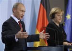 German Chancellor Angela Merkel, right, and Russian Prime Minister Vladimir Putin hold a news conference after their talks at the Chancellery in Berlin on Friday, Jan.16, 2009.