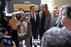 French former President Nicolas Sarkozy, center left, and his wife, Carla Bruni-Sarkozy, center right, pose with well-wishers after casting their votes in the first round of French legislative elections in Paris, France, Sunday, June 10, 2012.