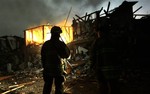 Firefighters use flashlights to search a destroyed apartment complex near a fertilizer plant that exploded earlier in West, Texas, in this photo made early Thursday morning, April 18, 2013.