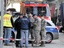 German police and US soldies talk after a gunman fired shots at U.S. soldiers on the bus outside Frankfurt airport, Germany, Wednesday, March 2, 2011 killing two people and wounding two before being taken into custody. The attack Wednesday afternoon came as the bus sat outside Terminal 2 at the airport. The two killed were the bus driver and a passenger, and that one person suffered serious wounds and one light injuries.