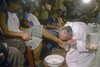 File - In this picture taken March 20, 2008 Argentina's cardinal Jorge Bergoglio, right, kisses the feet of a man during a mass with youth trying to overcome drug addictions in Buenos Aires, Argentina. Bergoglio, who chose the name of Pope Francis, is the 266th pontiff of the Roman Catholic Church.