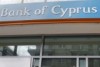 People line up to make transactions at an ATM outside a Bank of Cyprus branch in Athens.