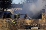 Ministry for Emergency Situations workers and fire fighters work at a site of a fire of a psychiatric hospital Friday morning, April 26, 2013.