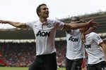 Manchester United's Robin Van Persie, left, celebrates his third goal against Southampton with teammates during their English Premier League soccer match at St Mary's stadium, Southampton, England, Sunday, Sept. 2, 2012.