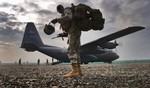  U.S. Army Sgt. 1st Class Ricky Bryant is last in line to board a C-130H2 Hercules aircraft at Bagram Air Base, Afghanistan, for a flight to Forward Operations Base Salearno, Afghanistan, on March 8, 2006. The aircraft and crew are assigned to the 185th A